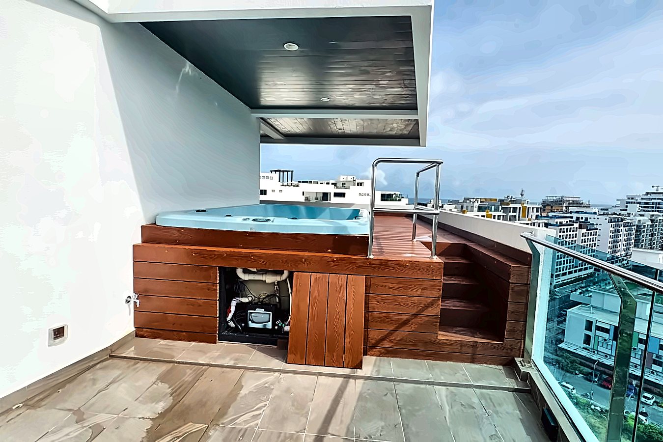 Rooftop spa and timber deck with the city and sea beyond